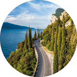 Cypresses alongside the Gardesana Occidentale, the highway on the western shore of Lake Garda, Italy 